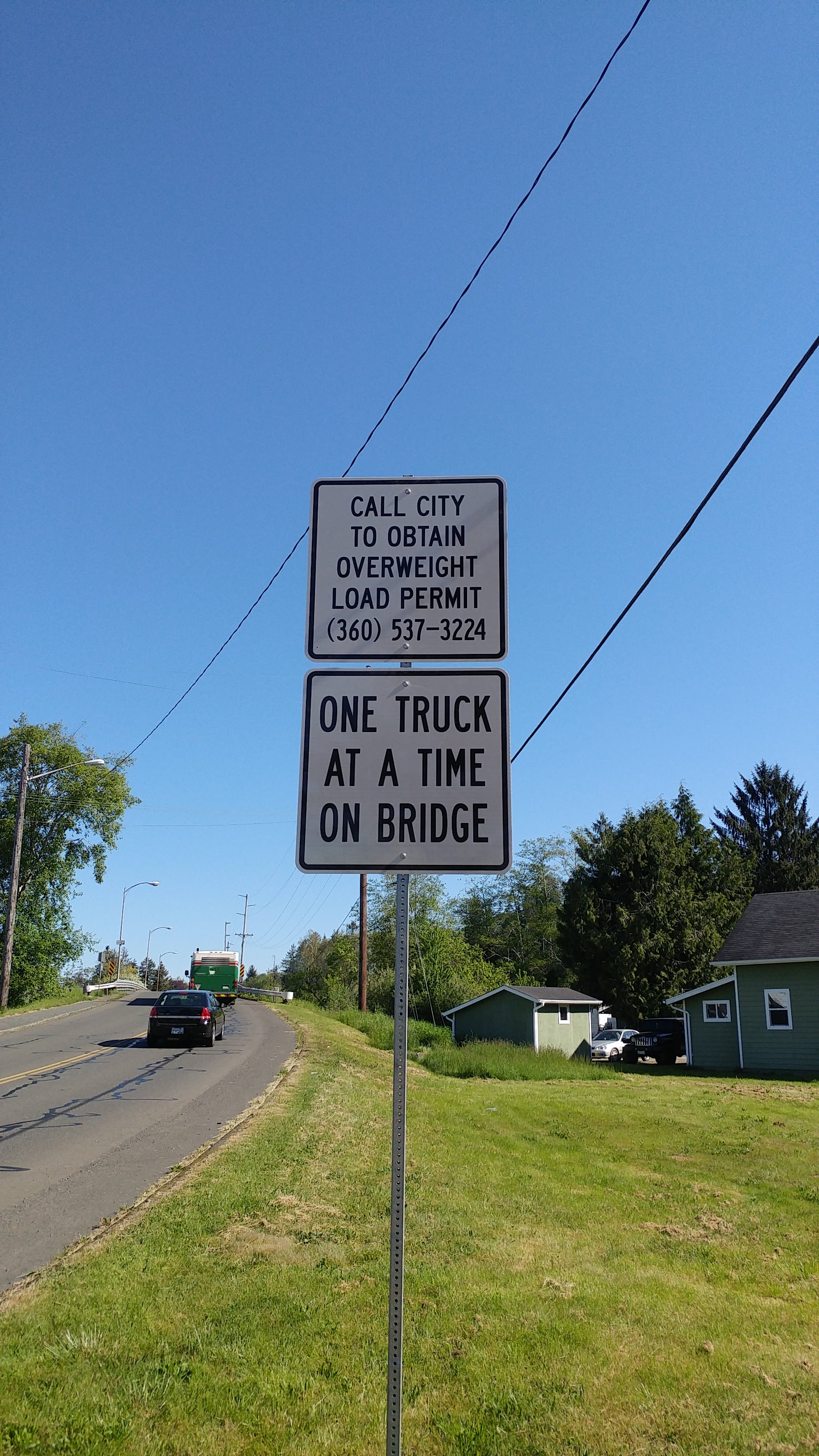Warning sign for vehicle weight restrictions on bridge. 
