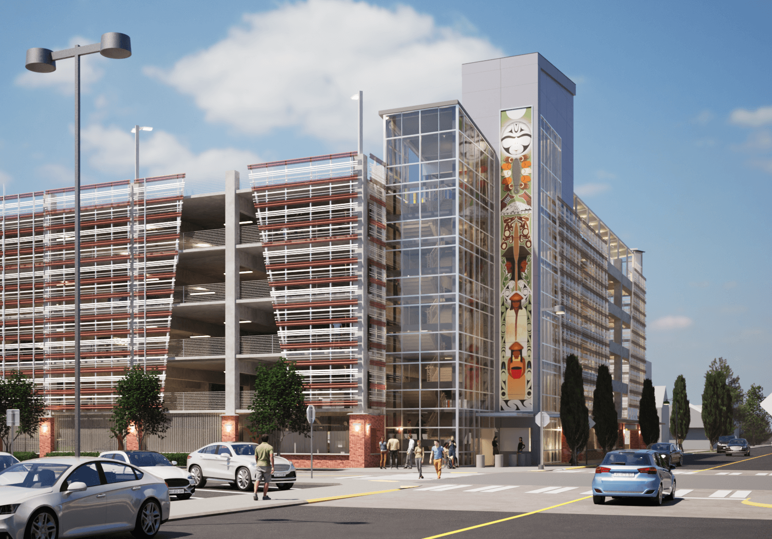 A parking garage, viewed from the corner. A stair tower covered in windows is prominent and an art piece runs the length of the staircase vertically.