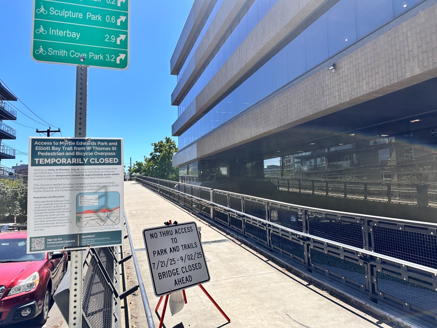 A sign installed at the east entrance to the W Thomas St Pedestrian and Bicycle Overpass.