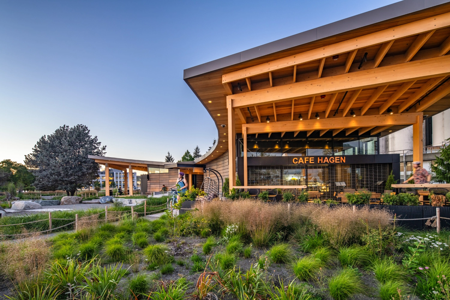 A view of the amenities building showing the curve of the roof in a semi circle and patio space on each end.
